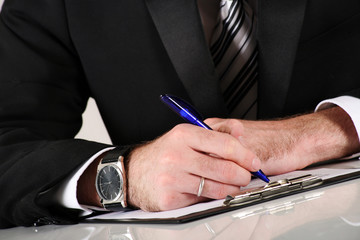 Young businessman at working and signing a contract