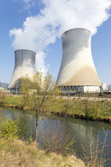 smokestacks of nuclear factory and river in summer