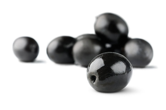 Isolated olives. Pile of black olive fruits isolated on white background, selective focus