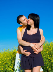 couple kissing on the field