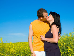 couple kissing on the field