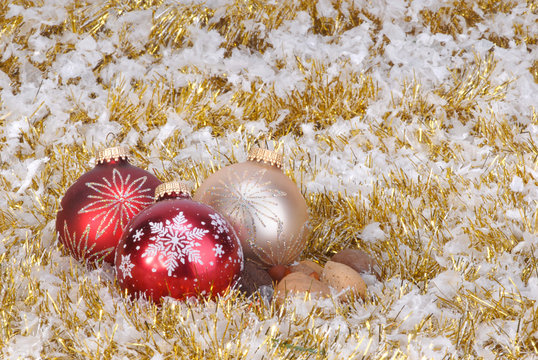 Christmas ornaments on background of garland and snok flakes