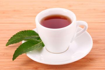 Cup  with mint on wooden table