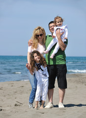 happy young family have fun on beach