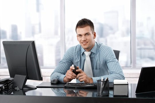 Young manager smiling at desk