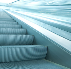 contemporary moving escalator stairs inside business blue hall
