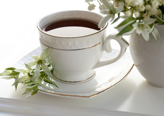 Lily of the valley and a cup of tea