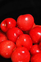 Sweet cherries isolated on black