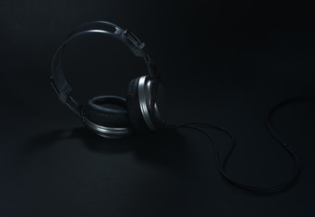 Fototapeta na wymiar Silver big headphones on black background