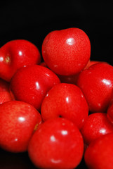 Sweet cherries isolated on black