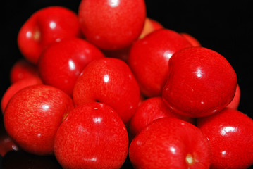 Sweet cherries isolated on black