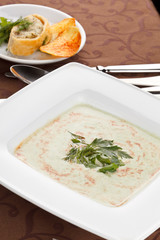 spinach cream soup with potato chips and fish pie