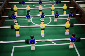 Soccer table game with yellow and blue players