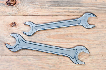 Wrenches on a wooden board.