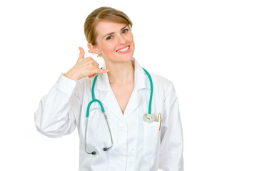 Fototapeta premium Smiling medical female doctor showing contact me gesture