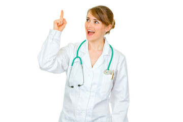 Surprised medical doctor woman with rised finger. Idea gesture.