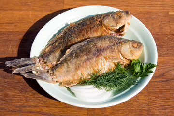 Fried fish crucian in plate