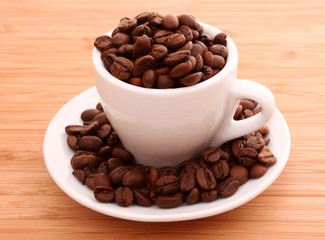 coffee beans and a cup isolated on brawn