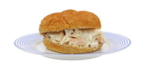 Chicken sandwich on blue striped plate