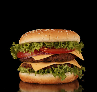 Delicious hamburger isolated on black background