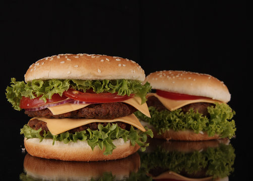 delicious hamburgers on black background