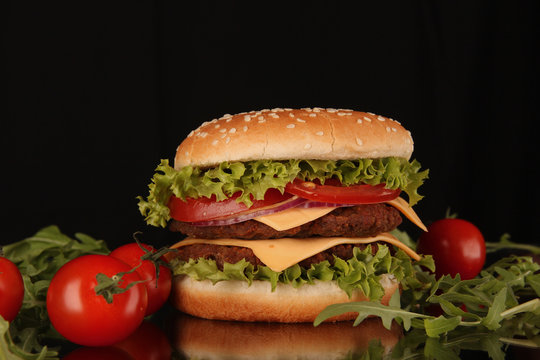 delicious hamburger on black background