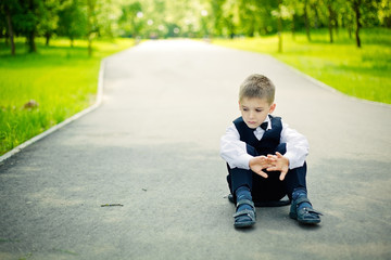 boy sitting down in a park