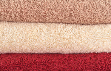 Fototapeta na wymiar Different colored bath towels lying upon each other
