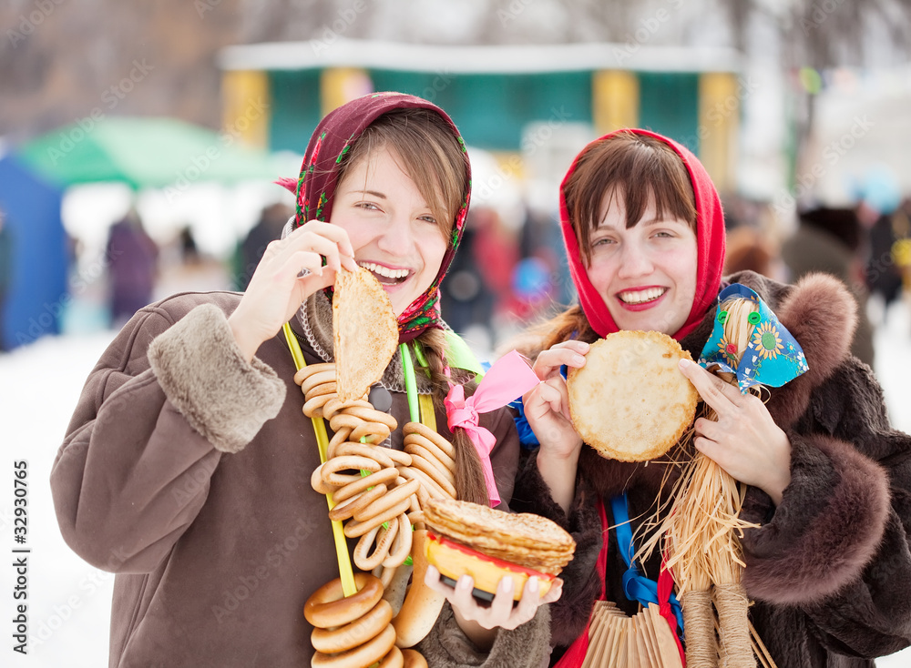 Wall mural Women  tasting pancake  during  Shrovetide