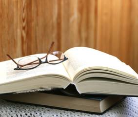 glasses on thick open book