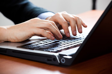 Businessman typing on the laptop