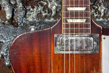 Well Worn Guitar Against Grungy Metal Background