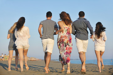 happy young  people group have fun on beach