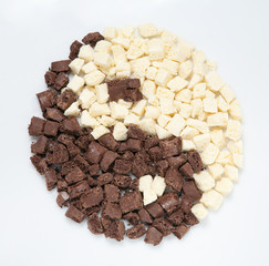 yin-yang of pieces of black and white chocolate.