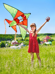Kid flying kite outdoor.