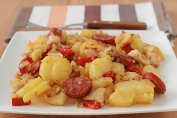 fried potato with chicken and sausages