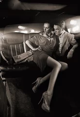 Foto op Plexiglas Knap paar knuffelen in een luxe limousine © konradbak