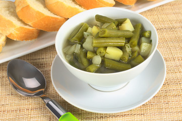 Green bean and potato hotpot in white bowl