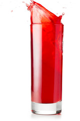 red liquid is spalsing in glass