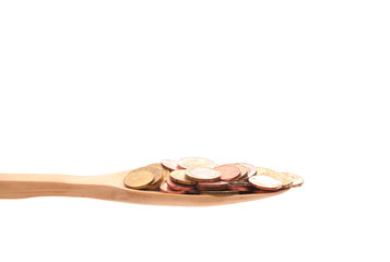 money  on a wooden spoon isolated on a white background