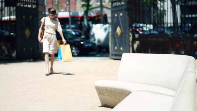 happy woman relaxing after shopping in the city, slow motion