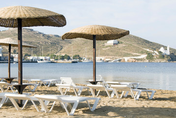 beach with umbrellas lounge chairs Ios Island Cyclades Greece