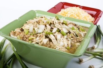 White chicken chili in ceramic dish with cheese & ingredients