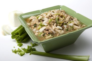 White chicken chili in green ceramic dish and ingredients