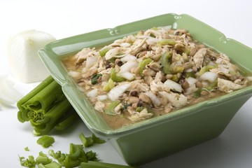 White chicken chili in green ceramic dish and ingredients