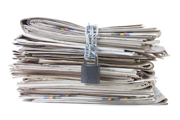 pile of newspapers with chains
