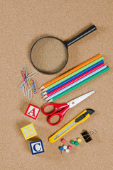 VARIOUS SCHOOL ACCESSORIES ON CORKBOARD
