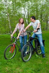 Happy young couple riding bicycles