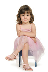 Pretty the little girl sits on a stool