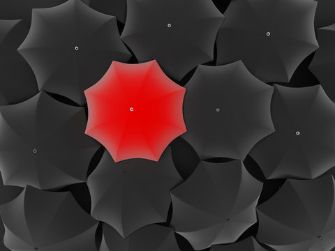 One unique red umbrella, among other black